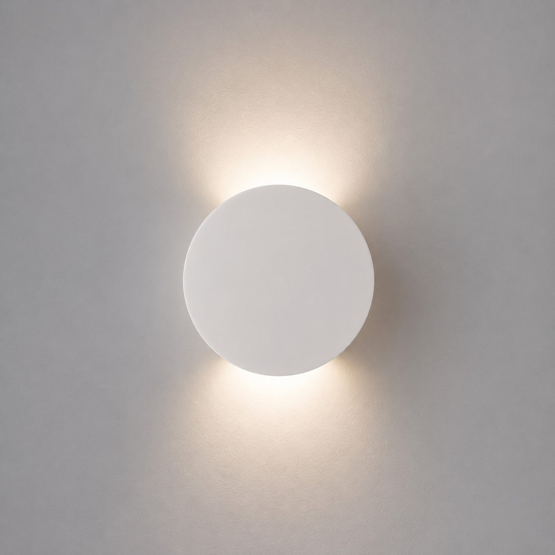 How Leiron Round Wall Light — Paintable White Plaster, Up & Down lights a room