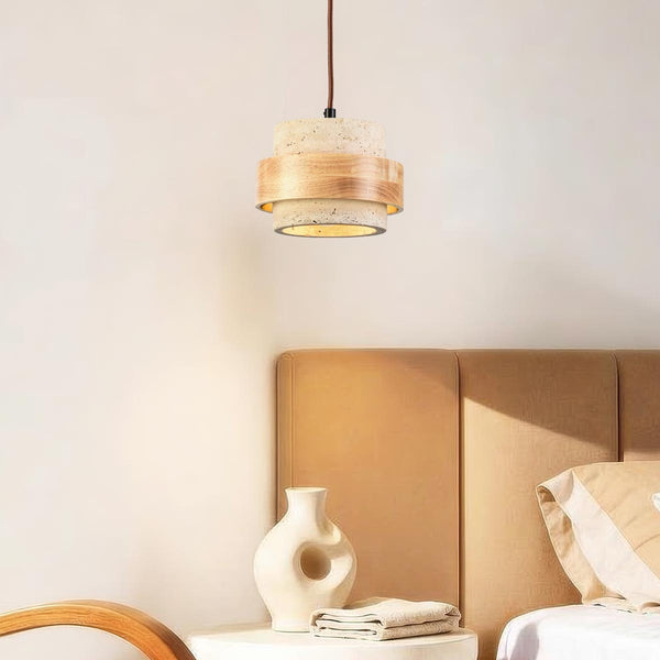 Enju travertine and light wood single pendant light suspended over dining table