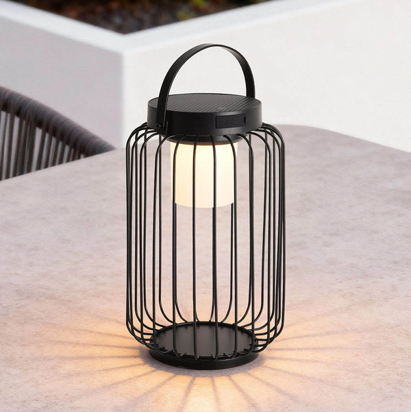 Glow Solar Lantern in black on garden patio at dusk