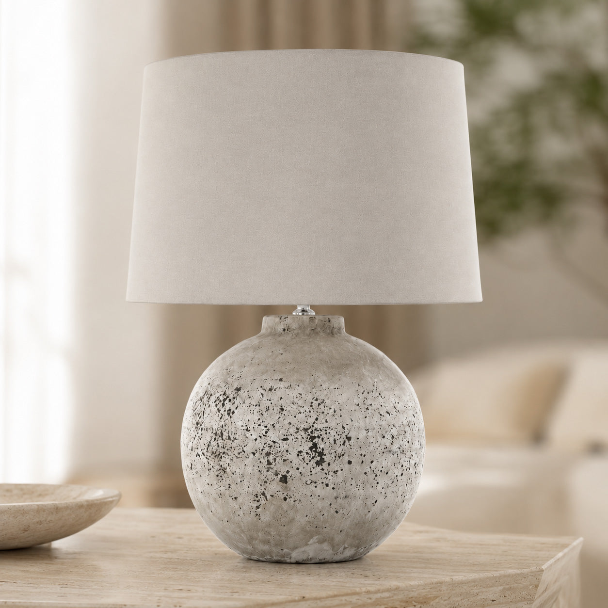 Tiber stone table lamp providing warm accent lighting in a living room