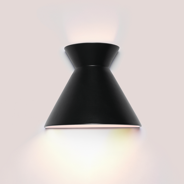 Kiro large black ceramic wall light casting light up and down a dark wall