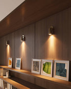 Close-up of brass cylinder wall light showing brushed metal finish and adjustable head