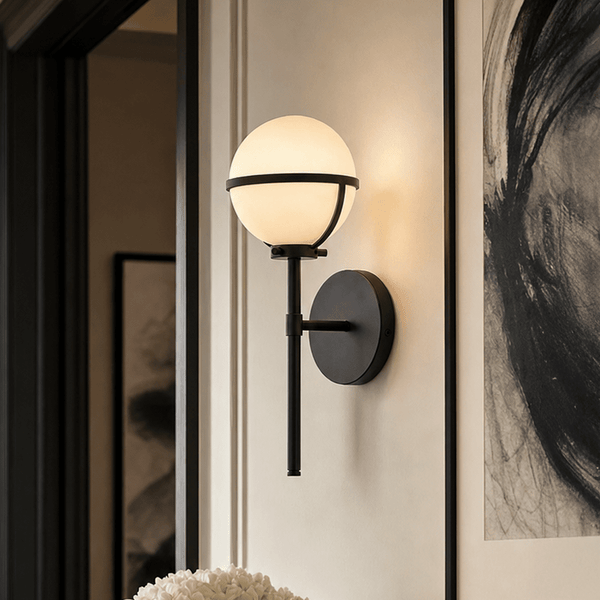 Nancy black wall light with orb detail mounted on white wall