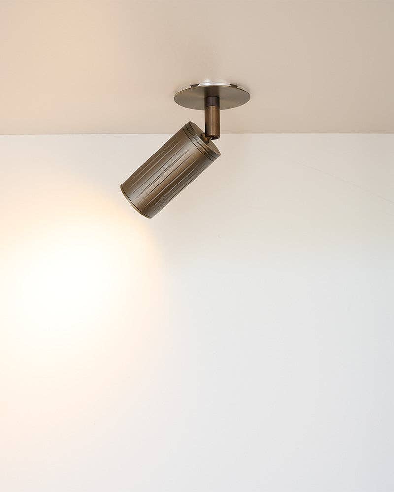 Danish design ceiling spotlight mounted on white ceiling in modern interior
