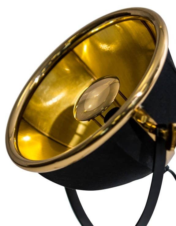 Close-up of brass accent detail on black tripod lamp base