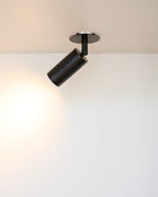 Box mount ceiling spotlight casting focused directional light beam