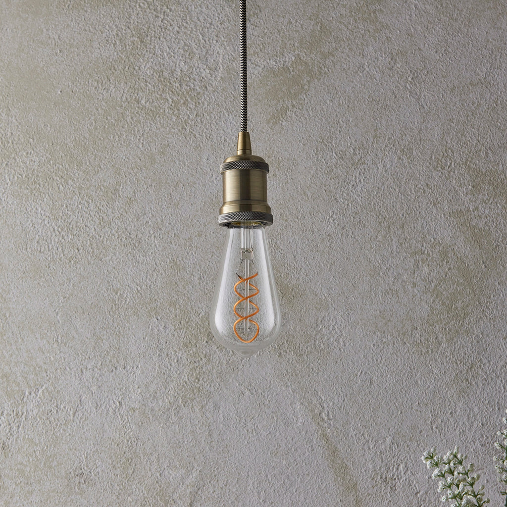 Close-up of double spiral decorative filament in dimmable LED bulb