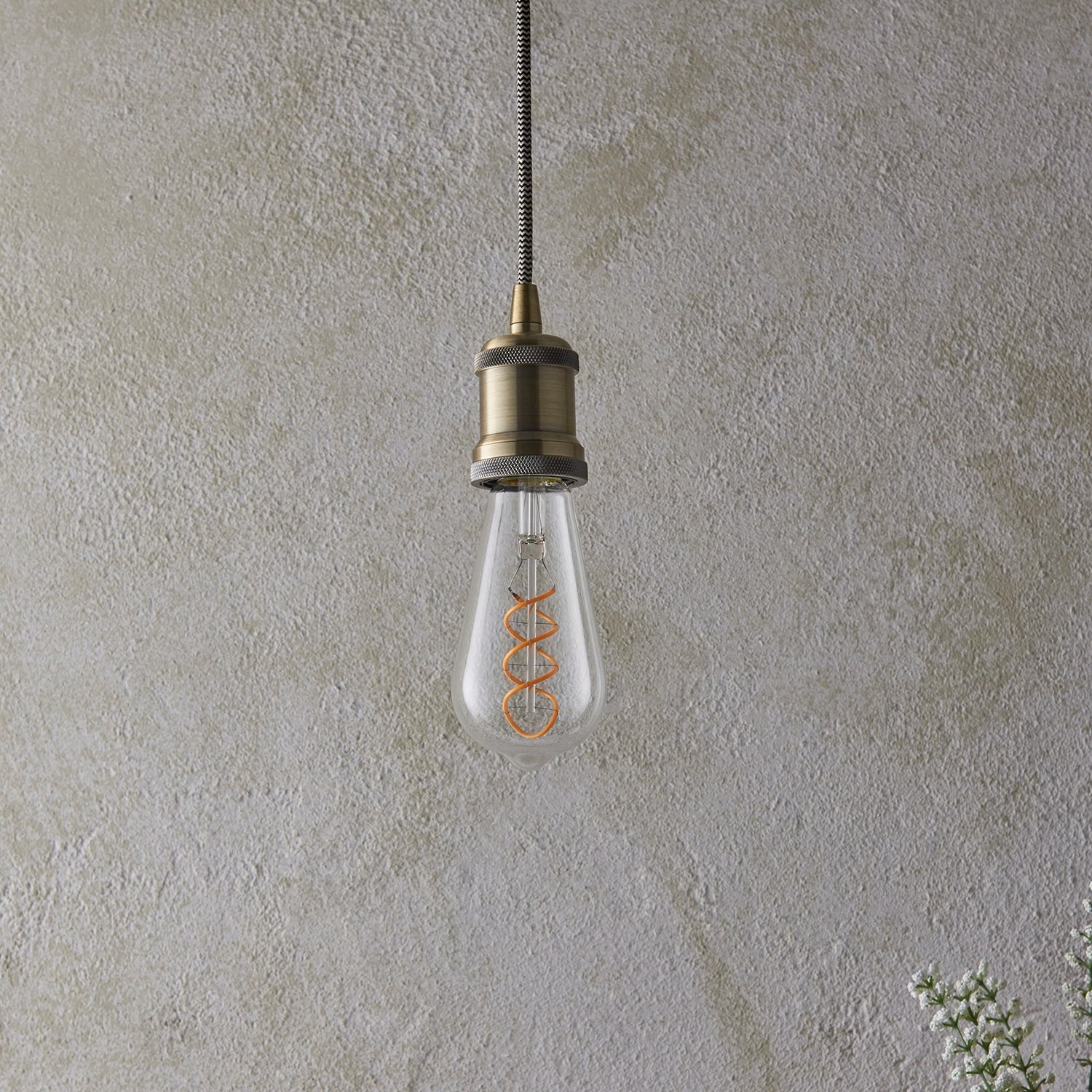 Close-up of double spiral decorative filament in dimmable LED bulb