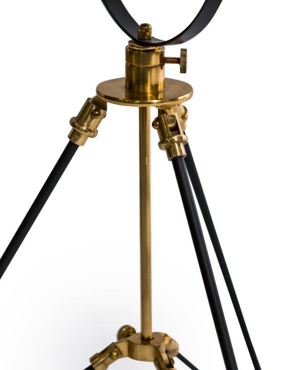 Valen tripod table lamp illuminated in modern living room setting
