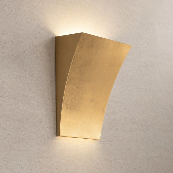 Alma tapered plaster wall light in gold leaf glowing warm at the top