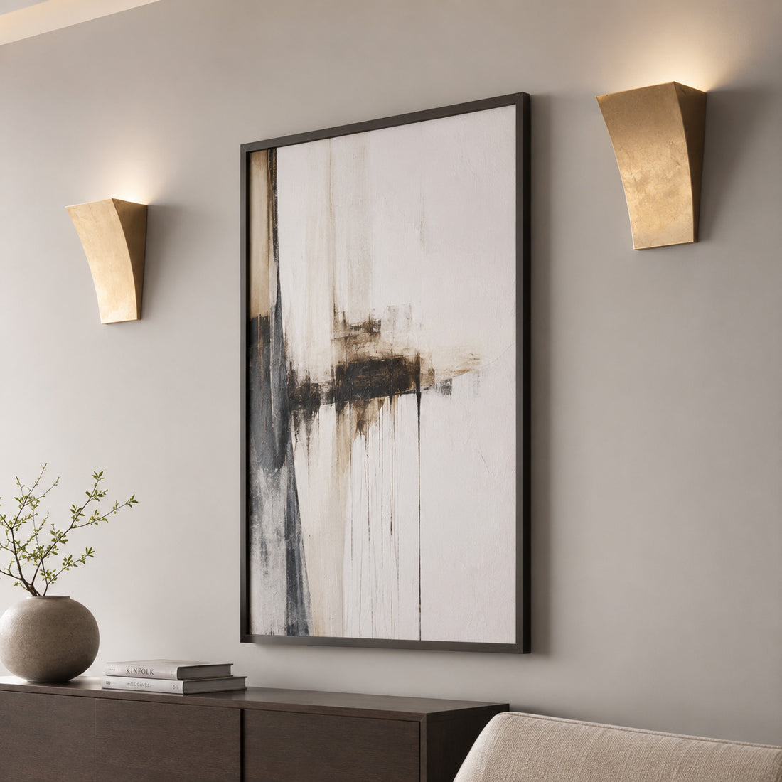 Pair of Alma gold leaf uplighters flanking monochrome abstract art