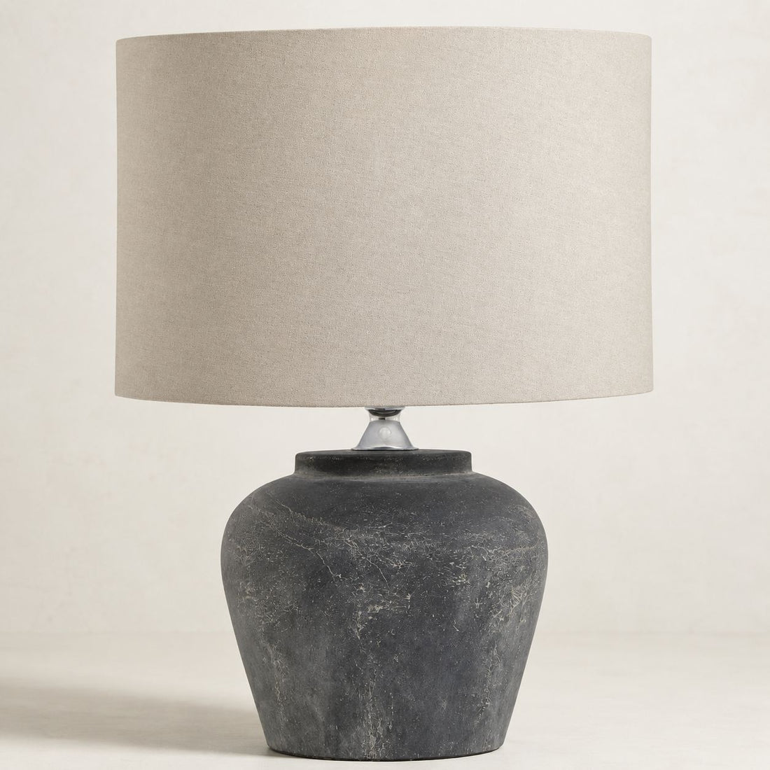 Amalfi grey stone-effect table lamp with natural linen shade, on white