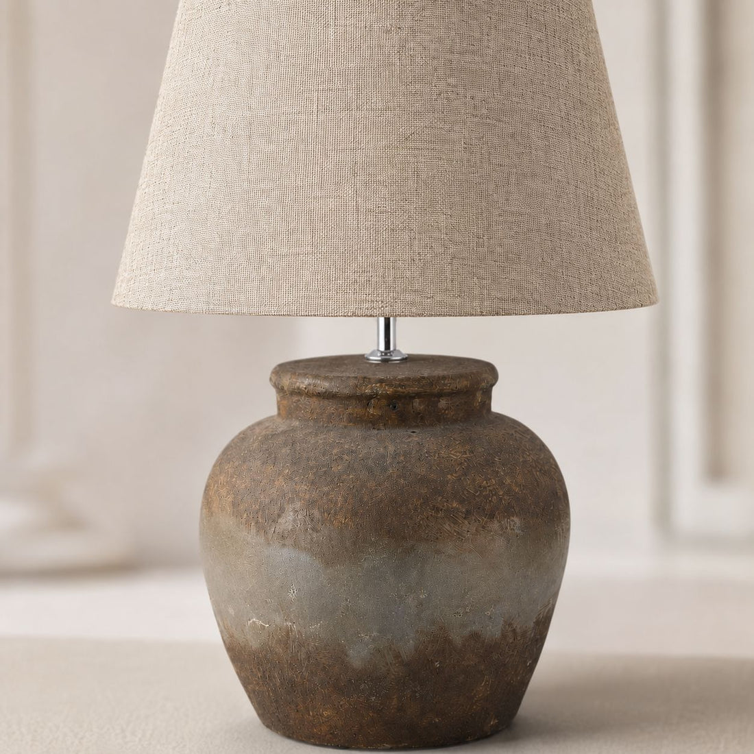 Castello aged stone table lamp with linen shade, close-up on white