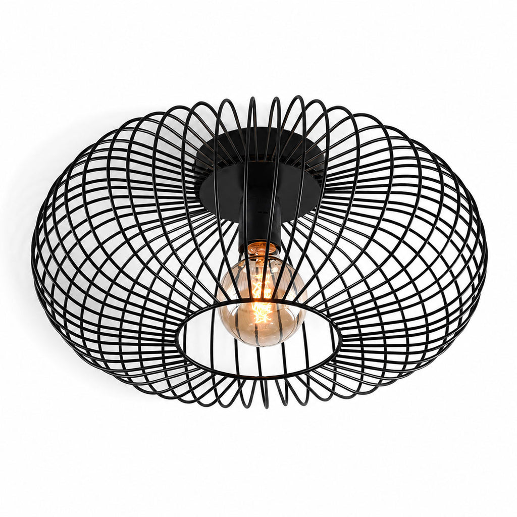 Cayo black wire cage flush ceiling light with filament bulb, angled view on white