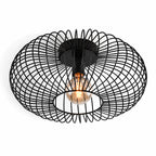 Cayo black wire cage flush ceiling light with filament bulb, angled view on white