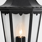 Corben half lantern, close-up of the candle-style bulb and clear glass panels