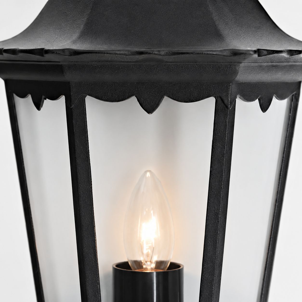 Corben half lantern, close-up of the candle-style bulb and clear glass panels
