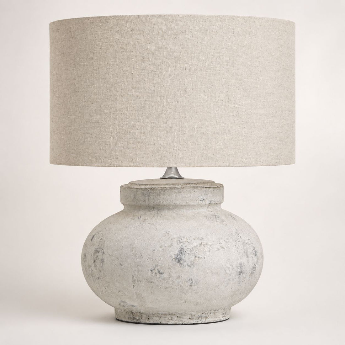 Darcy squat antique white table lamp with natural linen drum shade, on white