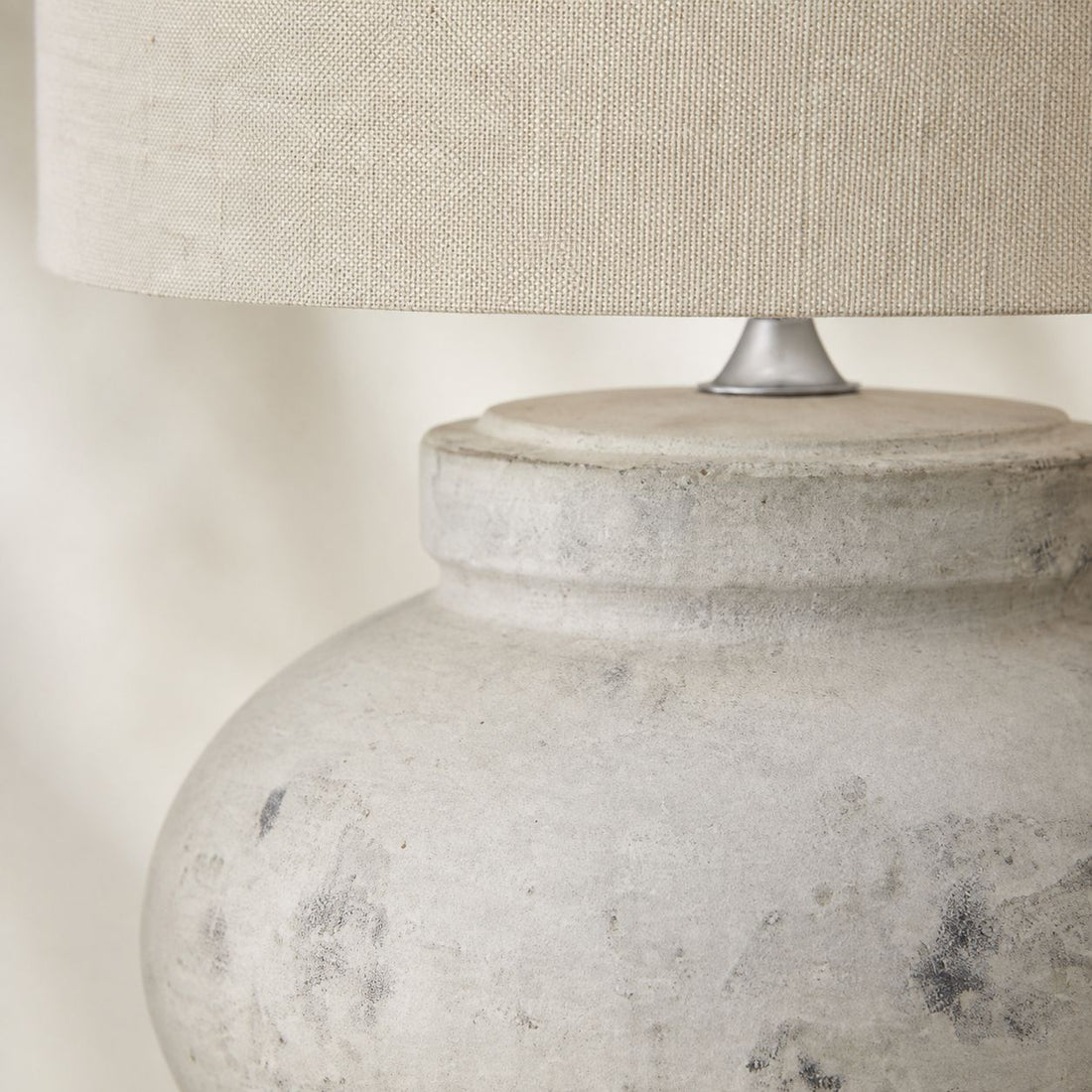Darcy squat table lamp, close-up of the antique white mottled stone base
