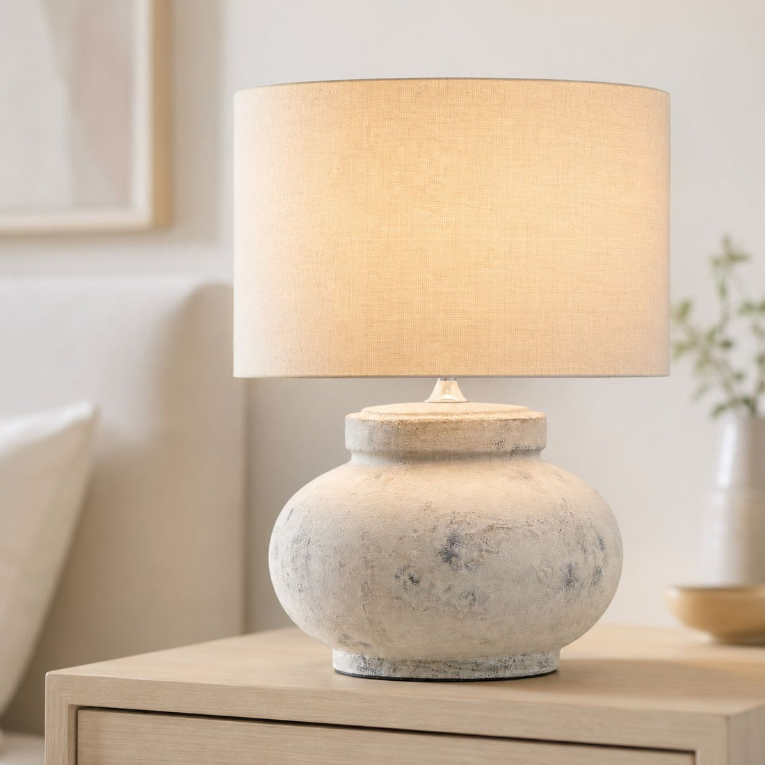 Darcy squat antique white table lamp with linen shade on a wooden console