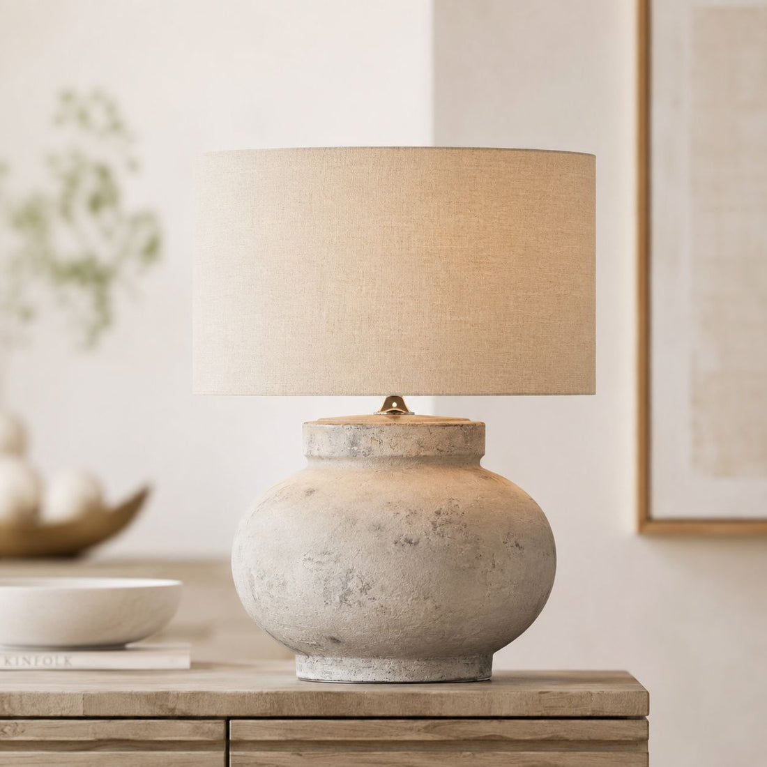 Darcy squat antique white table lamp on a wooden sideboard in a neutral room
