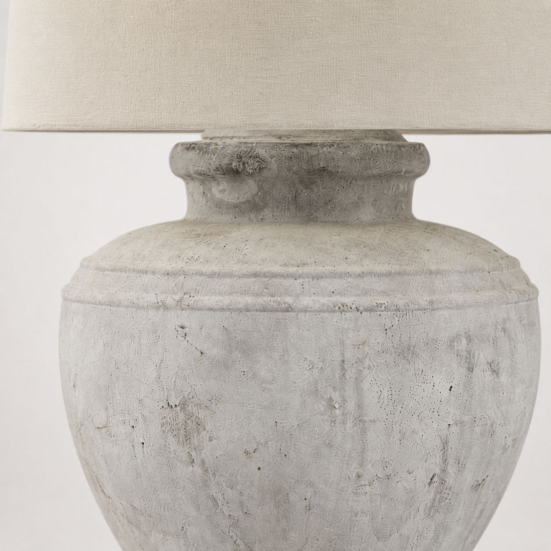 Darcy Chorus table lamp, close-up of the antique white ridged stone base