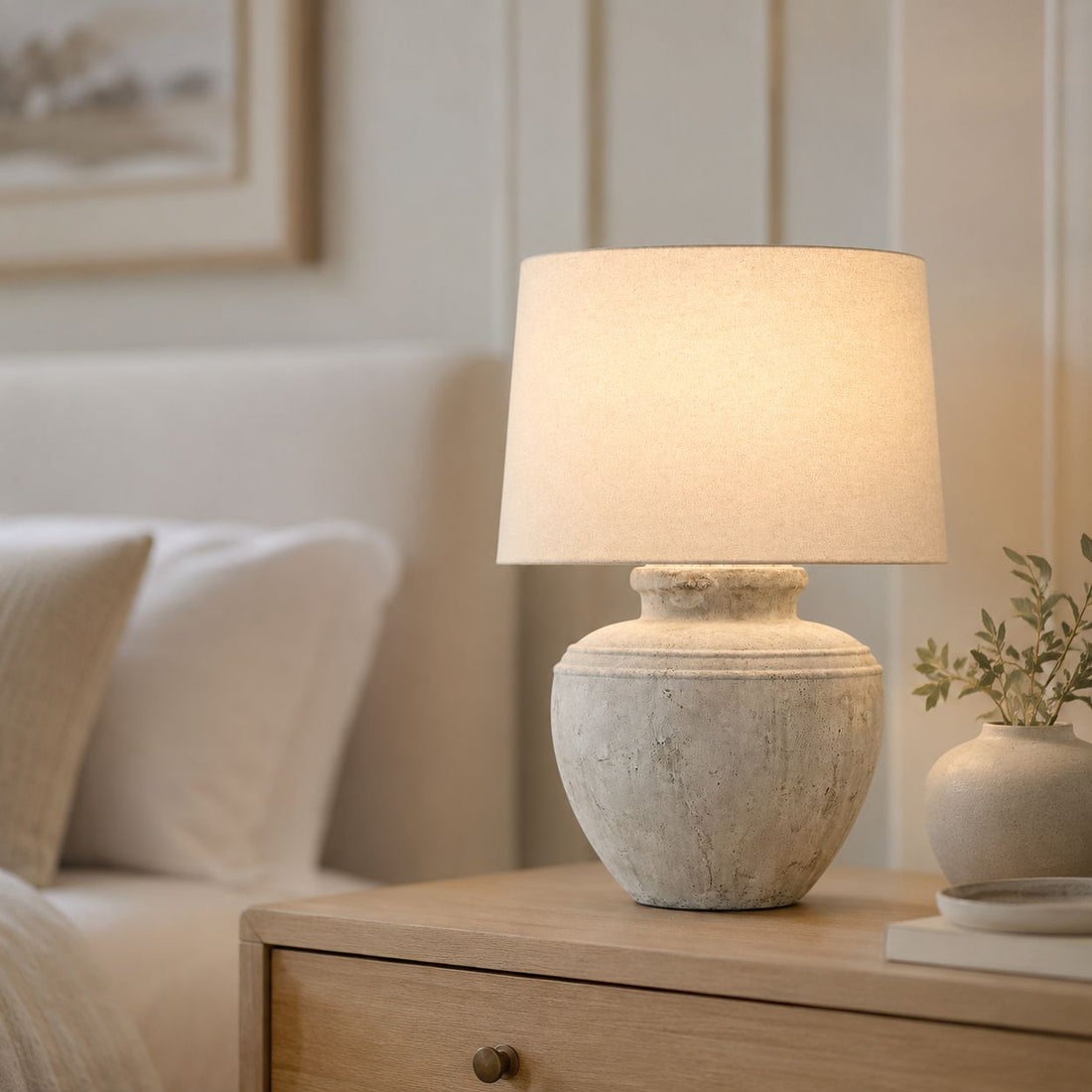 Darcy Chorus antique white table lamp on a console table by a window