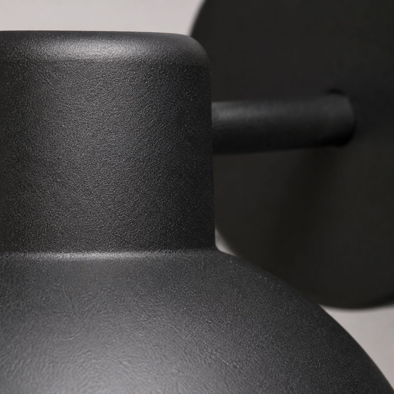 Hadsten matt black outdoor wall light, close-up of the arm and dome