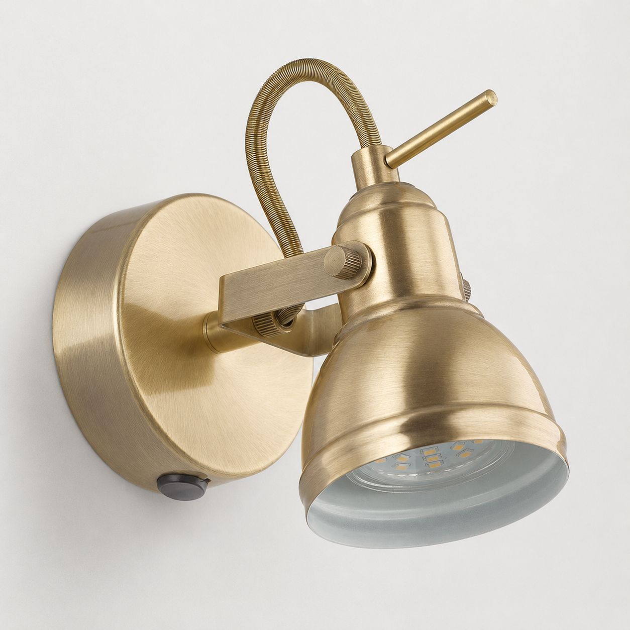 Harlow antique brass industrial wall spot light with toggle switch, on white