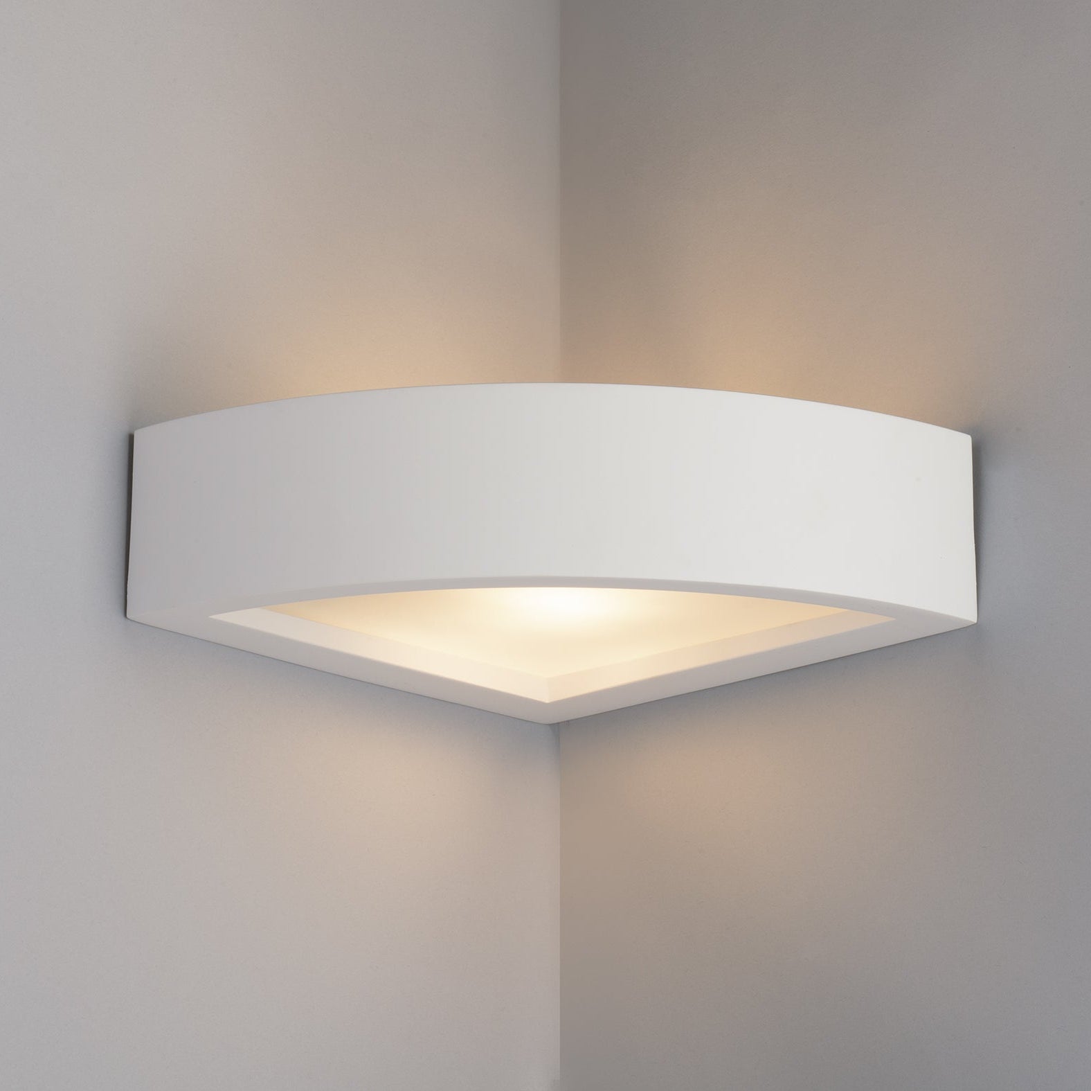 Paintable corner wall light installed on interior wall angle creating ambient glow