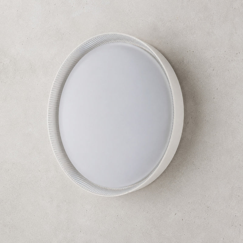 Kaos 40cm round LED ceiling light with ribbed trim on a grey wall
