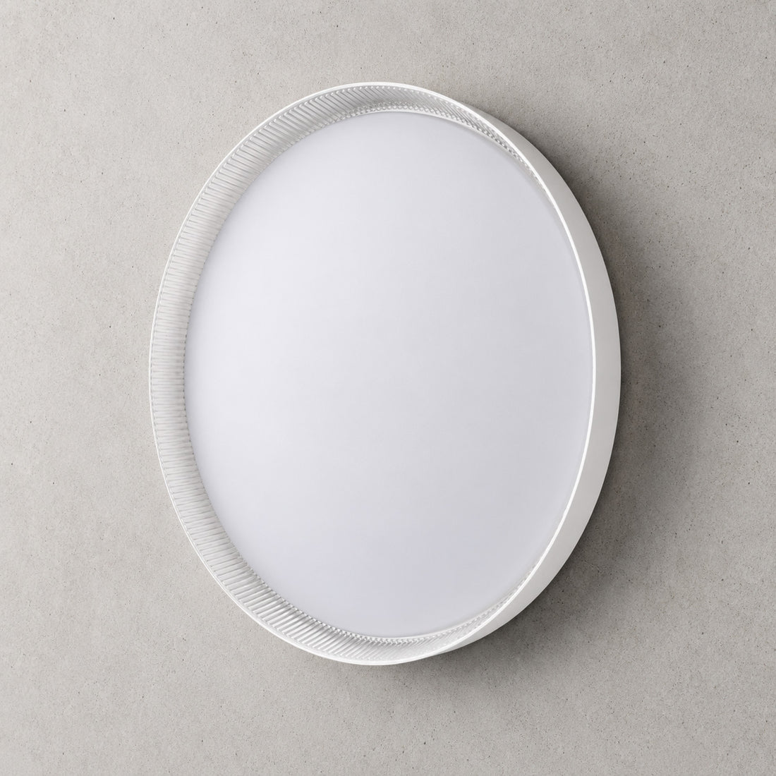Kaos 50cm round LED ceiling light in white with ribbed trim, lit cool white