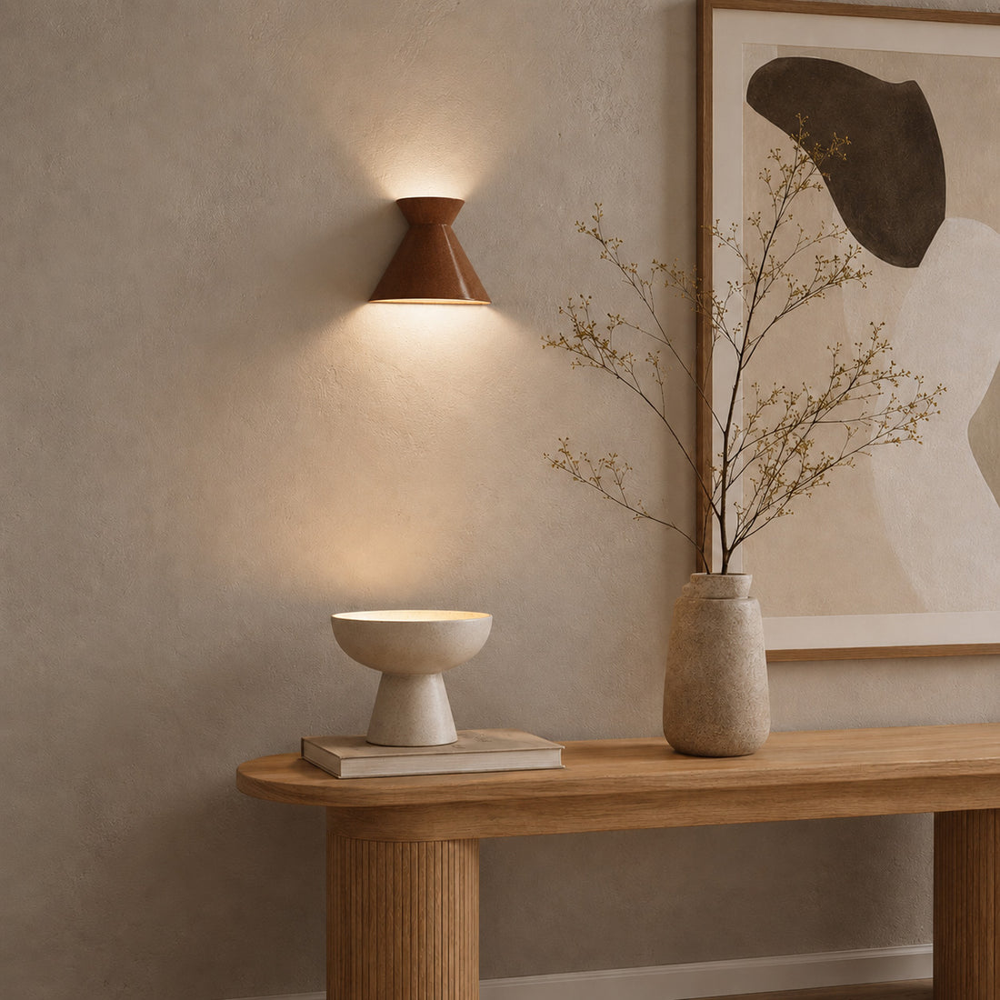 Small Kiro russet sconce lit above a floating oak shelf with ceramics
