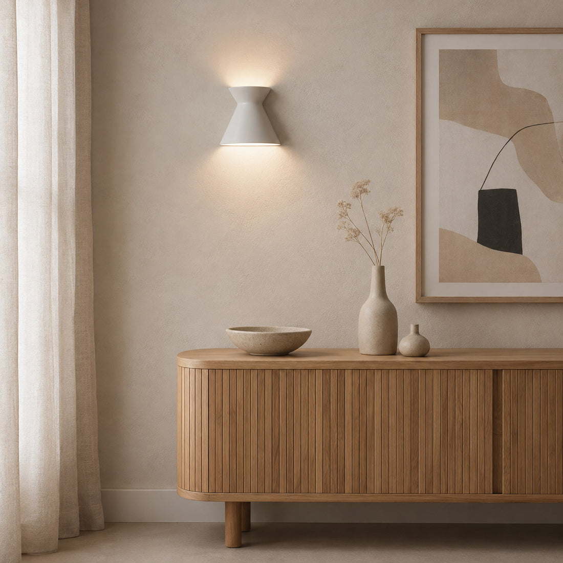 Kiro small pure white wall light lit by a linen curtain above an oak cabinet