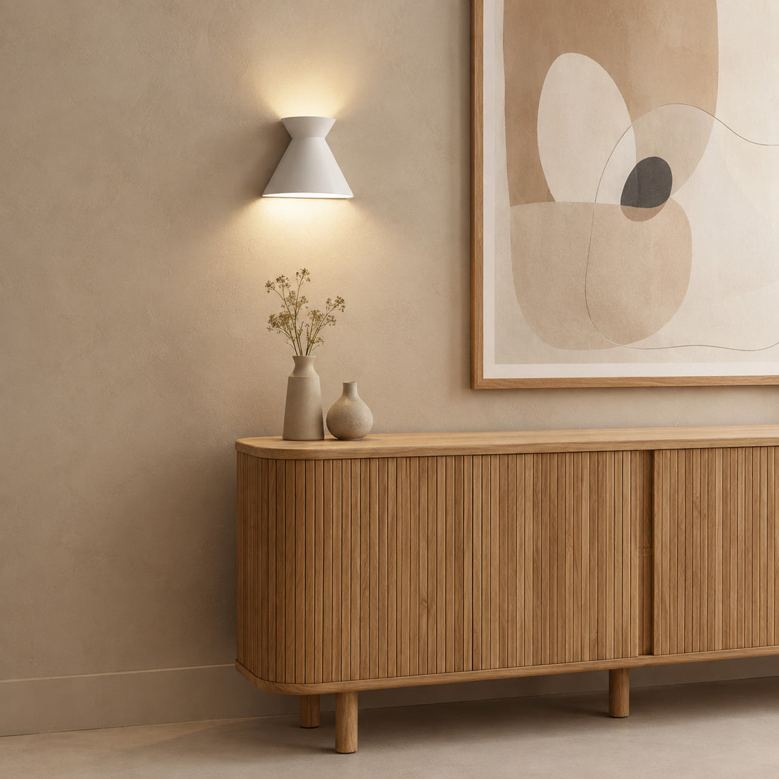 Small Kiro pure white sconce lit beside soft abstract art over a sideboard