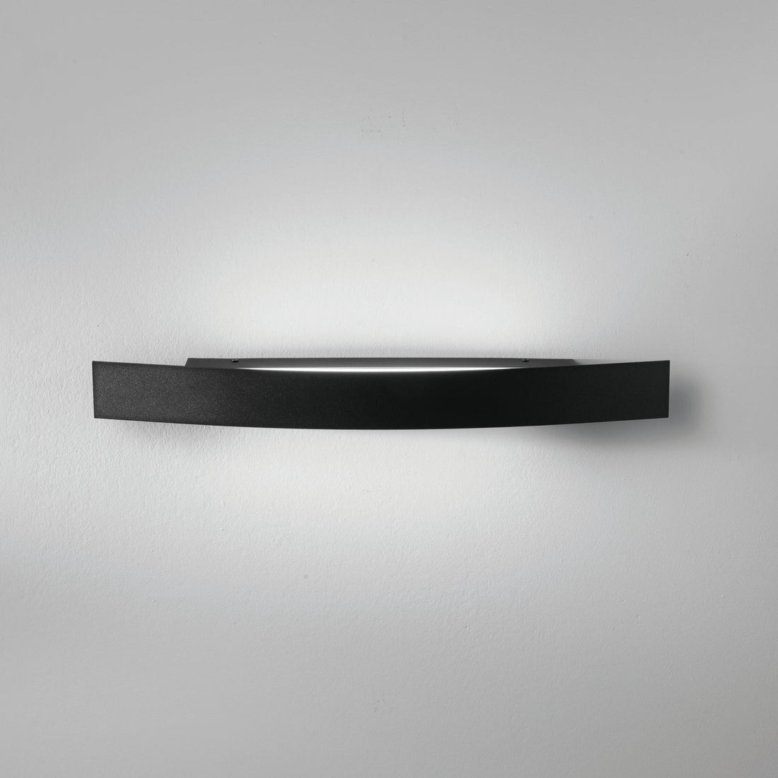 Spoiler black LED linear wall light mounted on white wall showing light wash effect