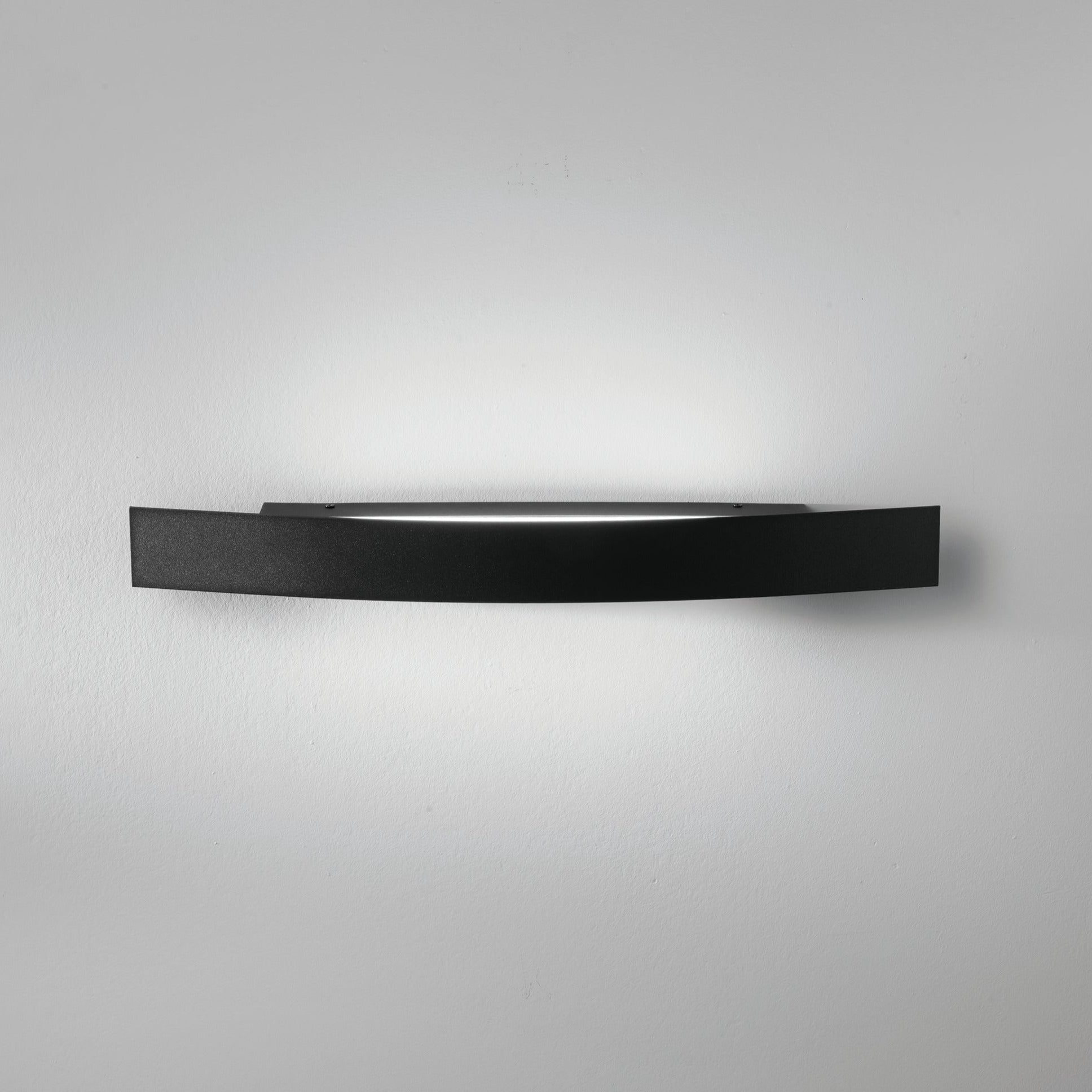 Spoiler black LED linear wall light mounted on white wall showing light wash effect