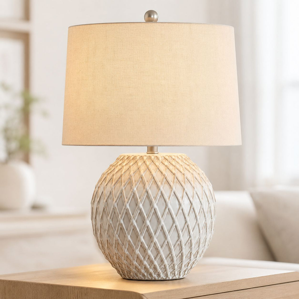 Lattice cream ceramic table lamp with diamond pattern base and linen shade in a living room