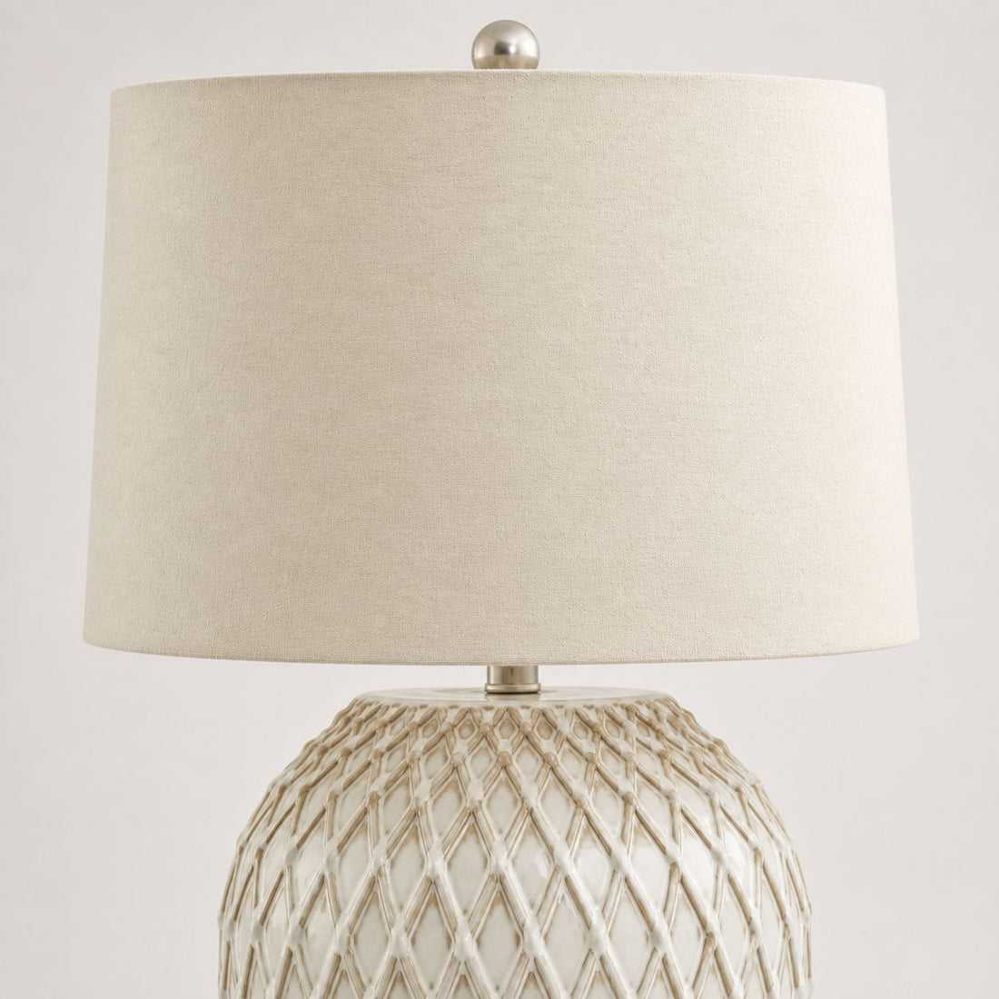 Lattice ceramic table lamp, close-up of the cream lattice pattern and linen shade