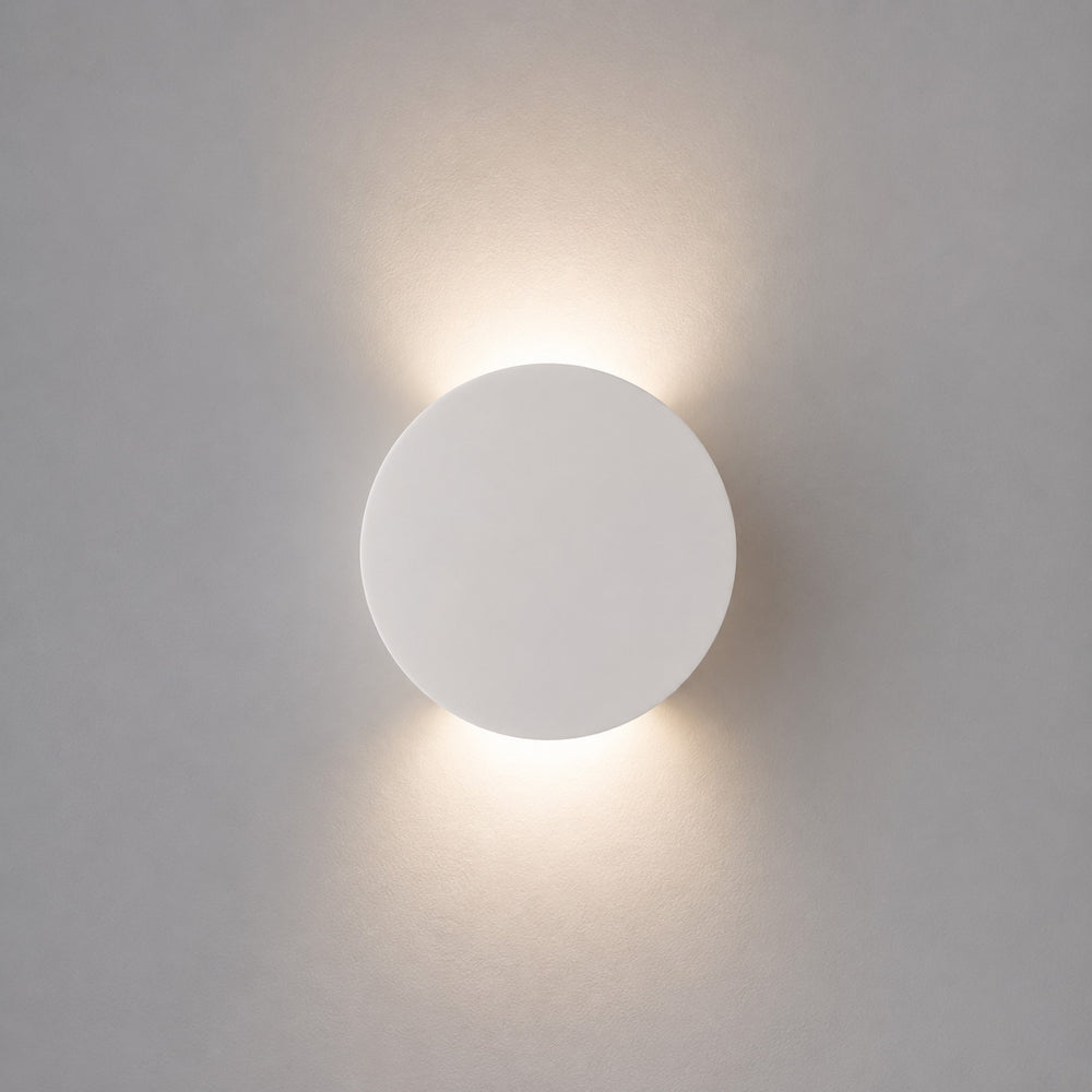 Leiron Round Wall Light — Paintable White Plaster, Up & Down after dark