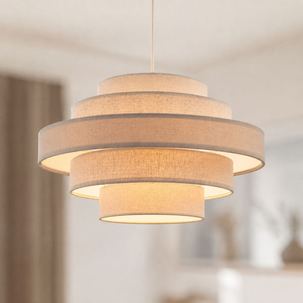 Linna oatmeal linen five-tier easy-fit pendant shade lit in a living room