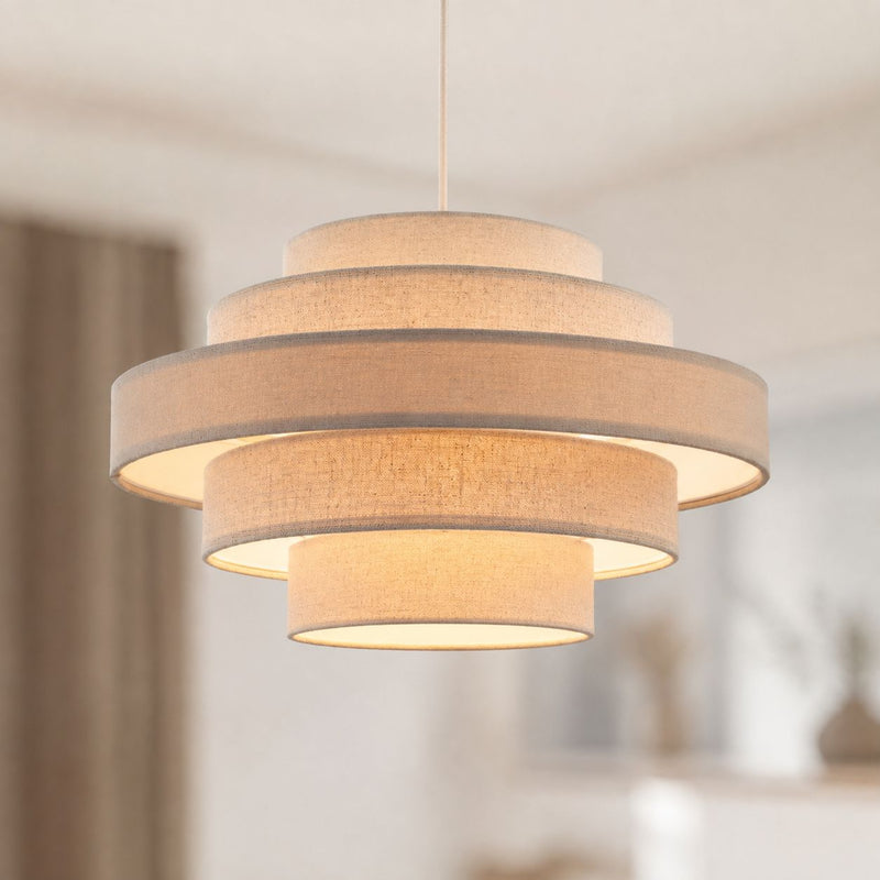Linna oatmeal linen five-tier easy-fit pendant shade lit in a living room