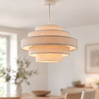 Linna five-tier oatmeal linen pendant shade lit in a neutral living room