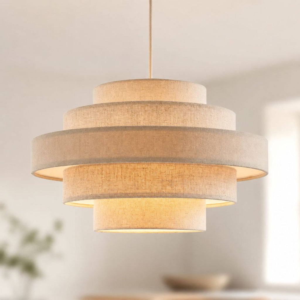 Linna oatmeal linen tiered pendant shade lit in a bright living room