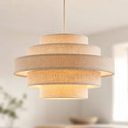 Linna oatmeal linen tiered pendant shade lit in a bright living room