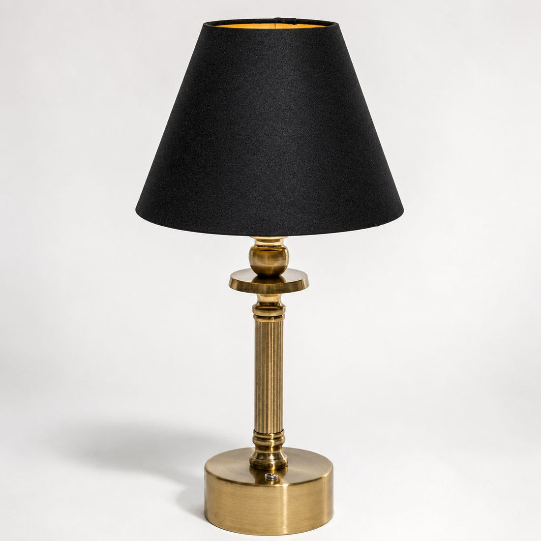 Lira brass cordless table lamp with black linen shade, front view on white