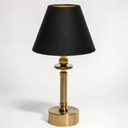 Lira brass cordless table lamp with black linen shade, front view on white