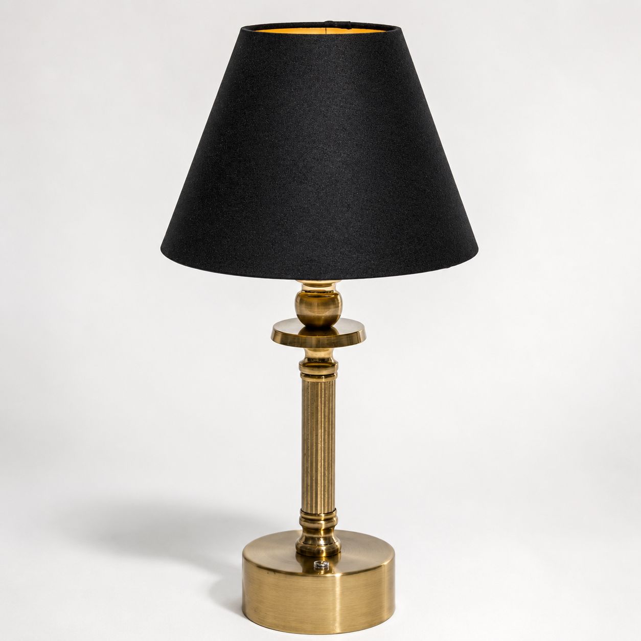 Lira brass cordless table lamp with black linen shade, front view on white