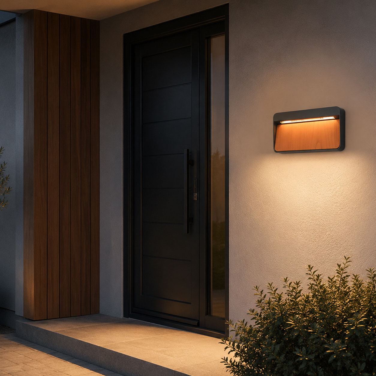Loren wood-front LED wall light beside a dark front door with timber cladding at dusk