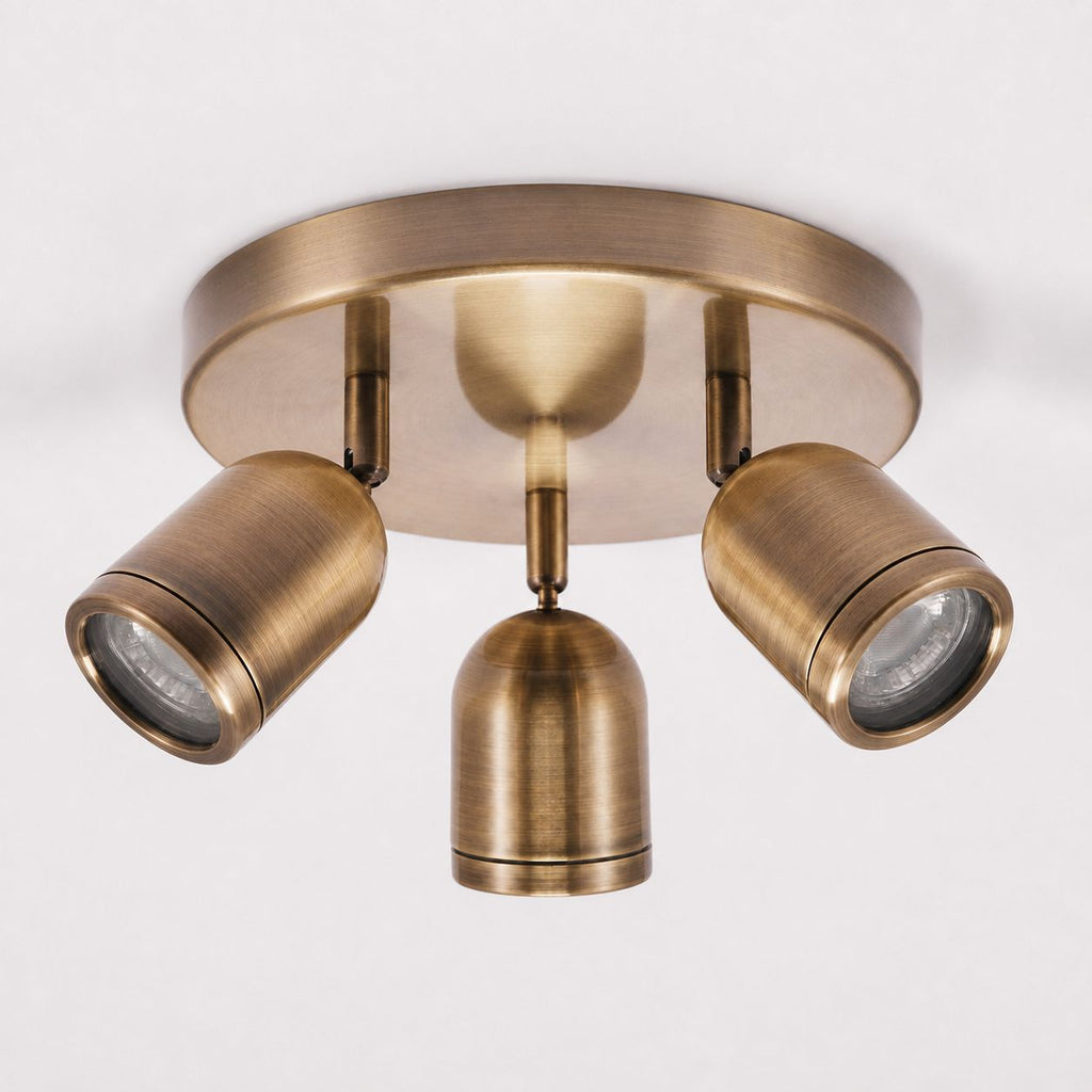 Lucca antique brass triple spotlight ceiling plate, angled view on white